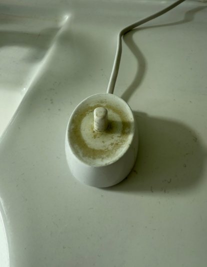 Before: Toothbrush charger with built-up residue