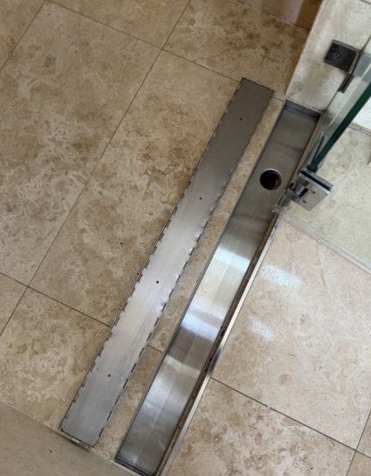 After: Shiny stainless shower drain